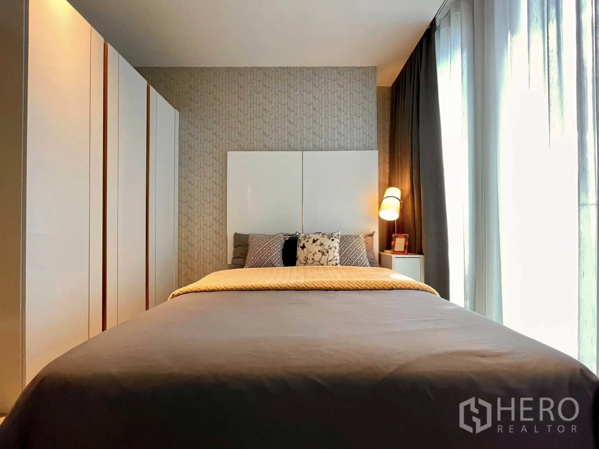 Condominium for rent in Bang Rak, Bangkok - Bedroom with bed, built-in wardrobe and soft lighting.