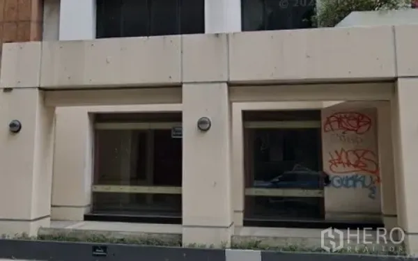 零售空间 出租在Khlong Toei, Bangkok - 街铺外立面，宽大展示橱窗与浅色墙面，位于空堤区。