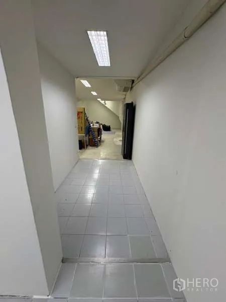 Office Space for rent in Khlong Toei, Bangkok - White corridor connecting to storage and utility areas.