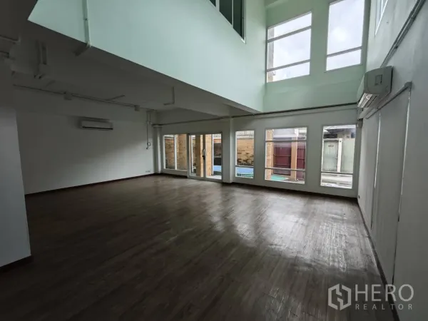 Office Space for rent in Prawet, Bangkok - Spacious ground-floor office with wide windows and sliding door to the courtyard.