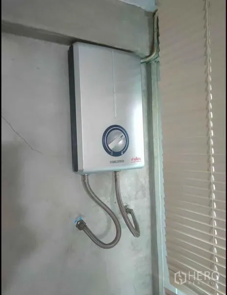 Detached House for rent in Wang Thonglang, Bangkok - Another wall-mounted electric water heater near window blinds.