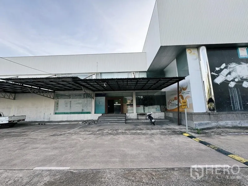 展厅 出租在Min Buri, Bangkok - 展示厅入口，带雨棚、台阶和停车位，便于接待客户。