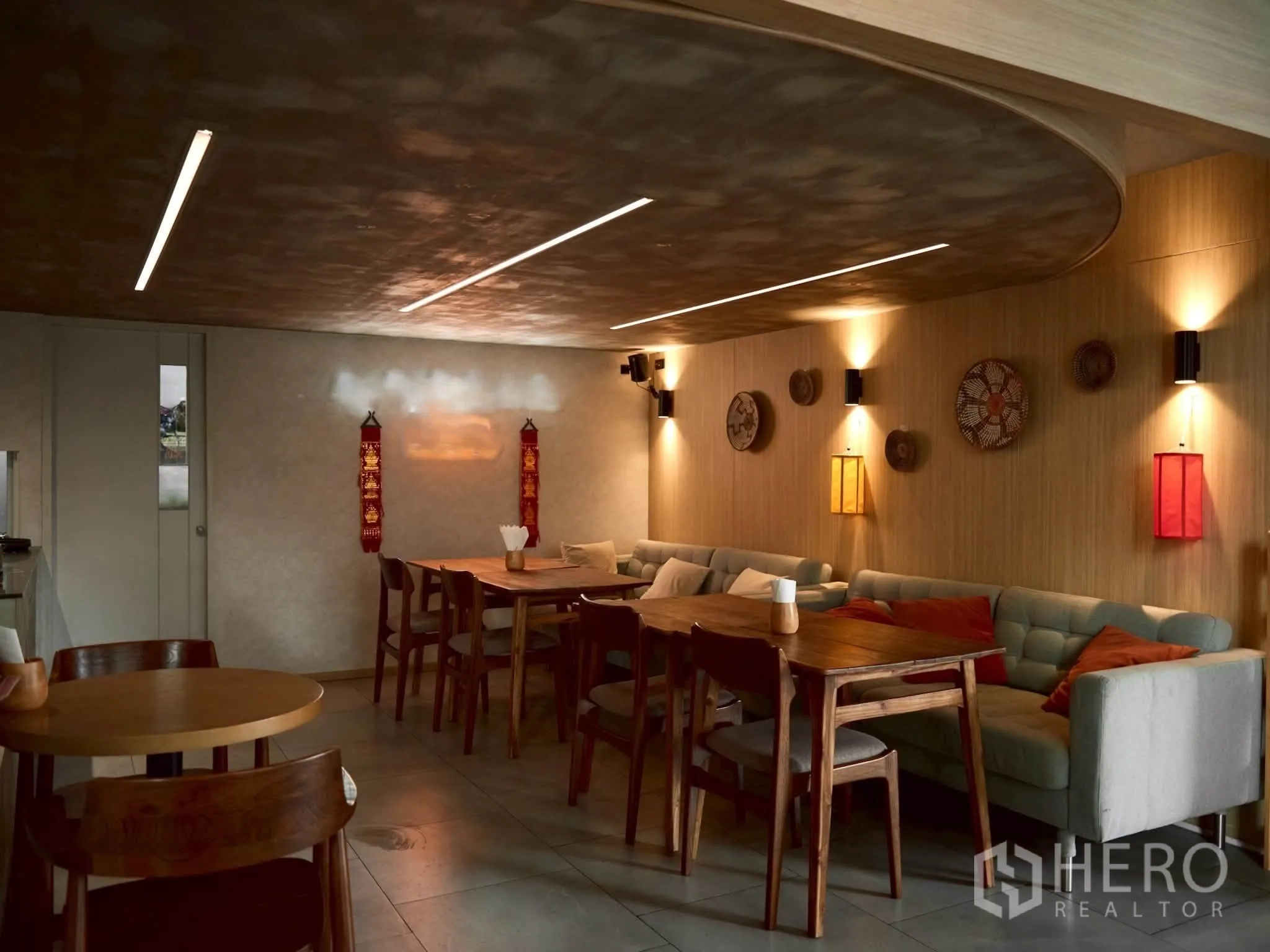Retail Space for rent in Watthana, Bangkok - Ambient lower level with sofas, wood tables, and linear ceiling lights.