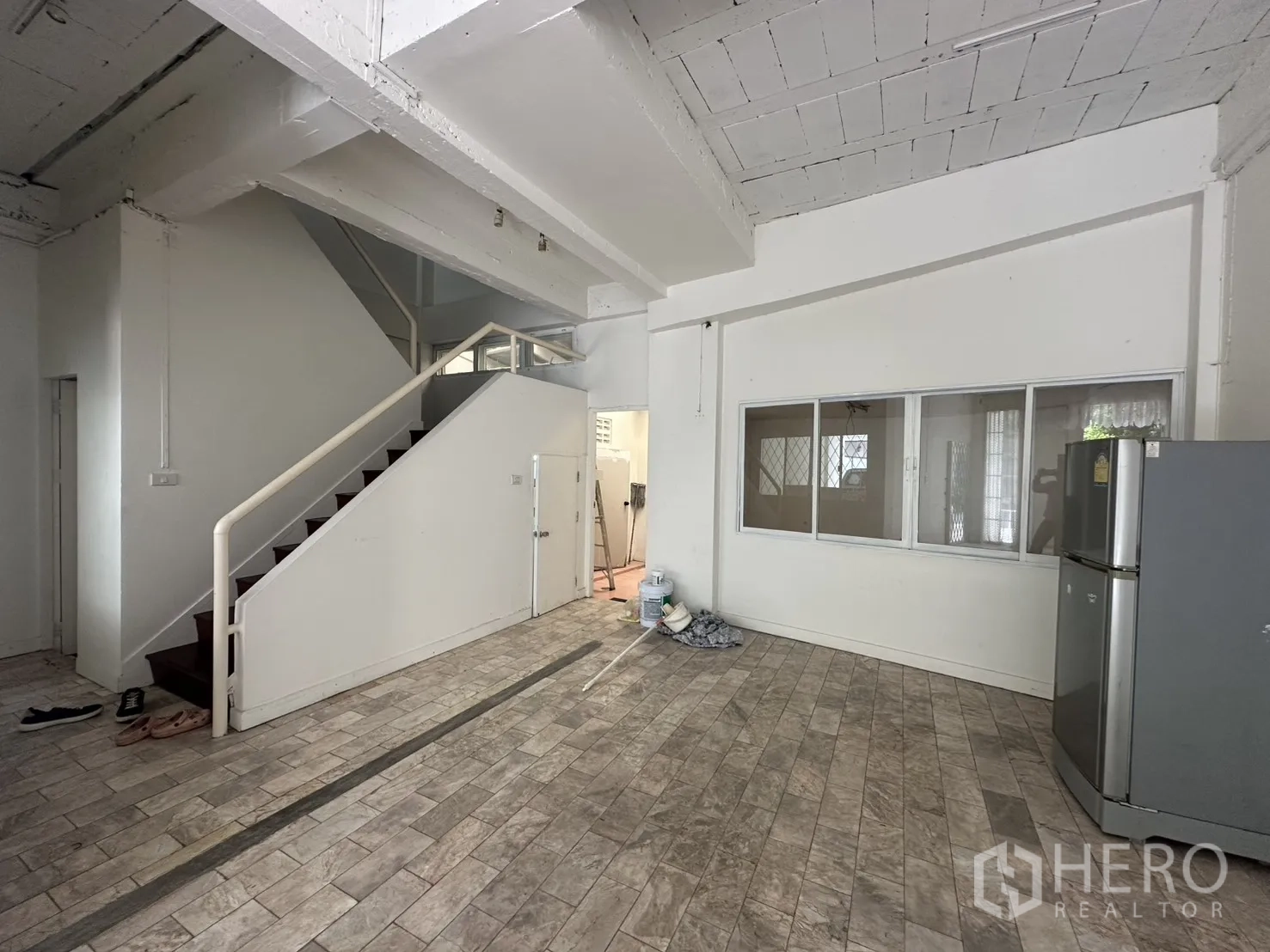 Home Office for rent in Watthana, Bangkok - Staircase and windowed partition beside the open office area.