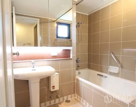 房间 出租在Khlong Toei, Bangkok - 浴室配立柱式洗手盆、镜柜、带淋浴的浴缸和小窗。