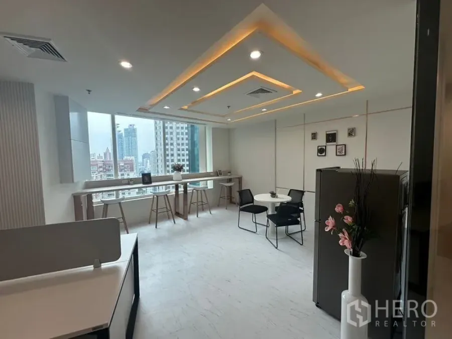 Office Space for rent - Bright open office with window bar seating, city skyline views and feature ceiling lighting.