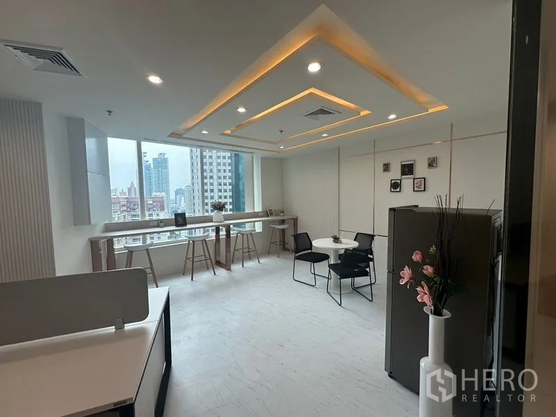 Office Space for rent - Bright open office with window bar seating, city skyline views and feature ceiling lighting.