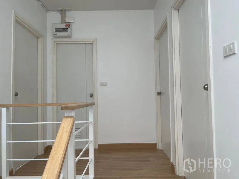 Townhouse for sale - Upstairs landing with white doors to bedrooms and bathrooms