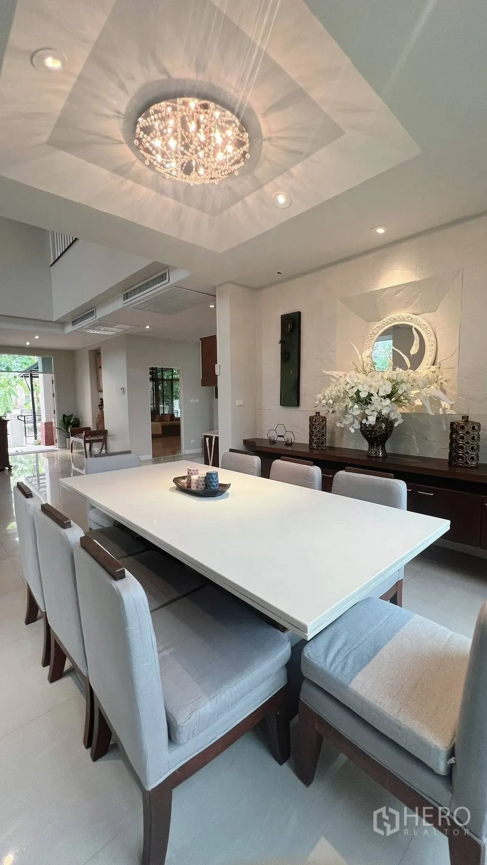 Detached House for rent in Lat Krabang, Bangkok - Sitting nook by large curved windows with curtains and greenery.
