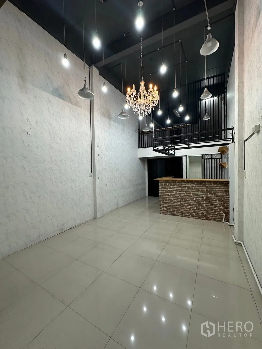 Shophouse for rent in Chatuchak, Bangkok - Ground-floor shop space with high ceiling, chandelier and mezzanine.