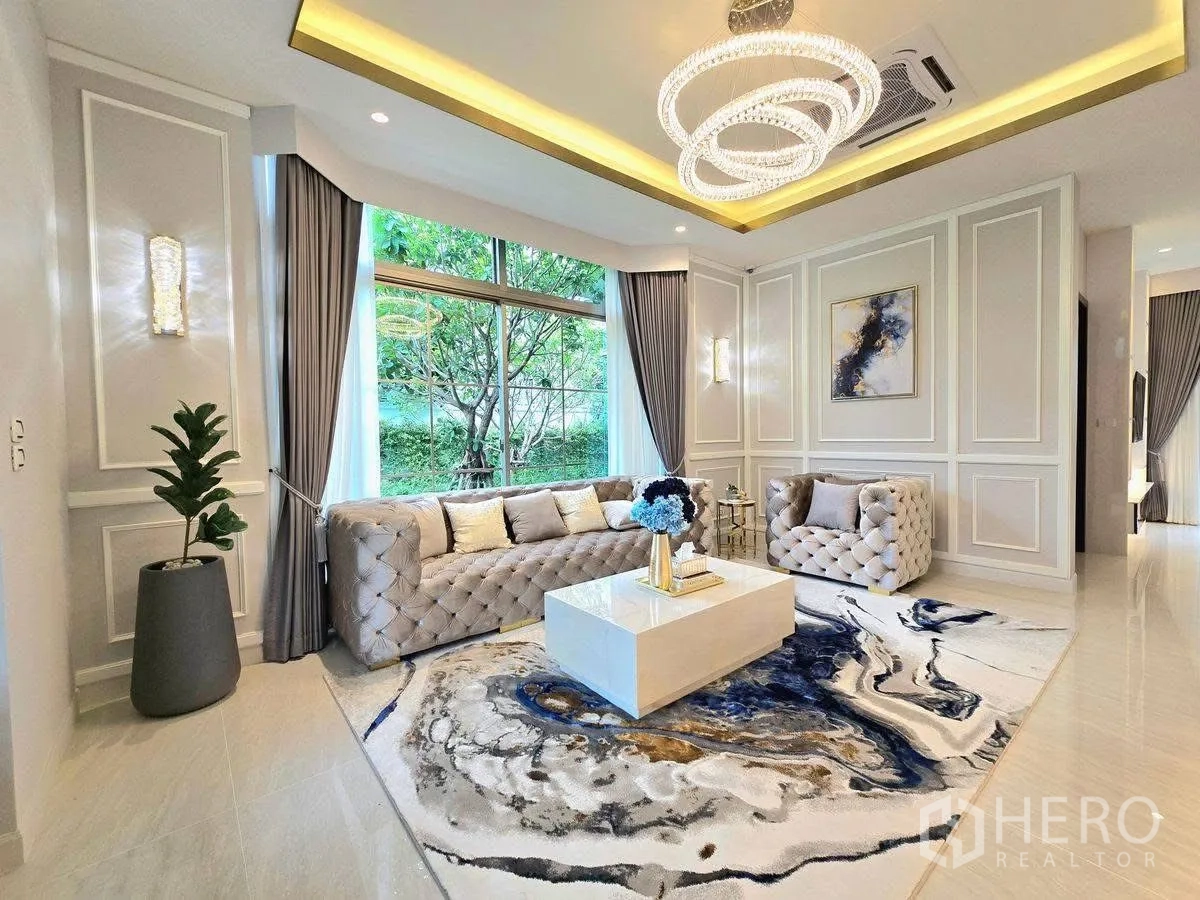 Detached House for rent or sale in Bang Phli, Samut Prakan - Corner living area with wall moulding, panoramic window to greenery and crystal chandelier.