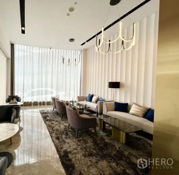 店屋 出租或出售在Din Daeng, Bangkok - 明亮接待休息区，落地窗、现代沙发与吊灯，位于Din Daeng商铺室内。