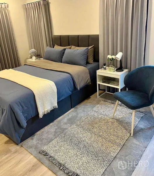 Detached House for rent in Bang Phli, Samut Prakan - Furnished bedroom with upholstered bed, side table and accent chair.