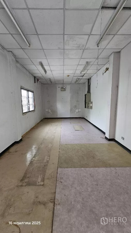 Retail Space for rent in Phra Khanong, Bangkok - Rear room with barred window, electrical panel and mixed flooring suitable for storage.