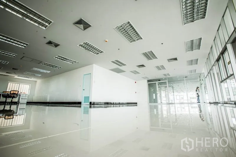 สำนักงาน ให้เช่าในBang Phli, Samut Prakan - มุมมองมุมต่ำของออฟฟิศกว้าง พร้อมห้องกระจกและไฟ LED แบบกริด