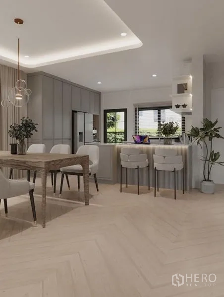 Detached House for rent in Bang Phli, Samut Prakan - Dining area with wood table for eight beside a breakfast bar and chevron floor.