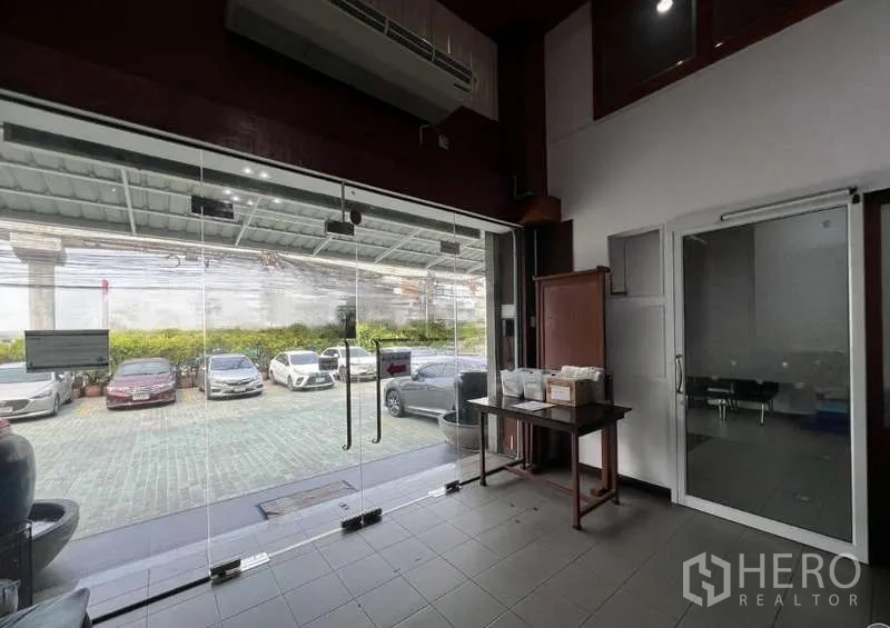 Office Space for rent - Ground-floor lobby with full-height glass doors opening to the car park.