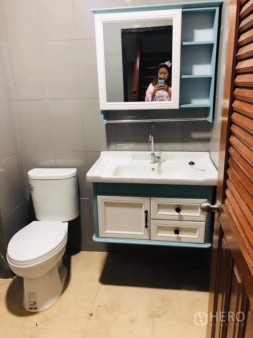 联排别墅 出租或出售在Huai Khwang, Bangkok - 现代浴室，坐便器、洗手台、镜柜与瓷砖墙。