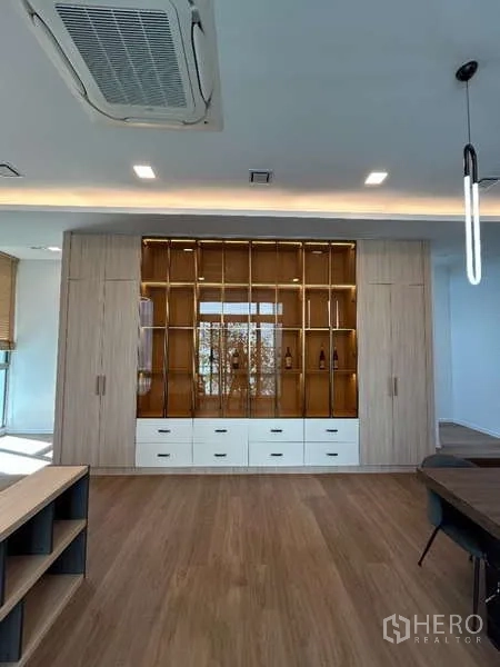 Detached House for rent in Saphan Sung, Bangkok - Feature wall of built-in display shelves with drawers in warm wood tones.