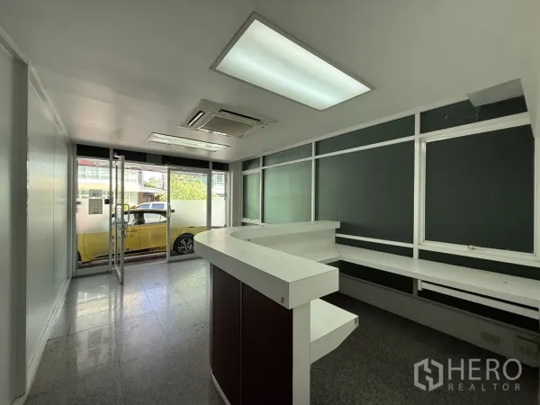 Office Space for rent in Bueng Kum, Bangkok - Reception area facing the glass entrance with built-in work counter and ceiling AC.