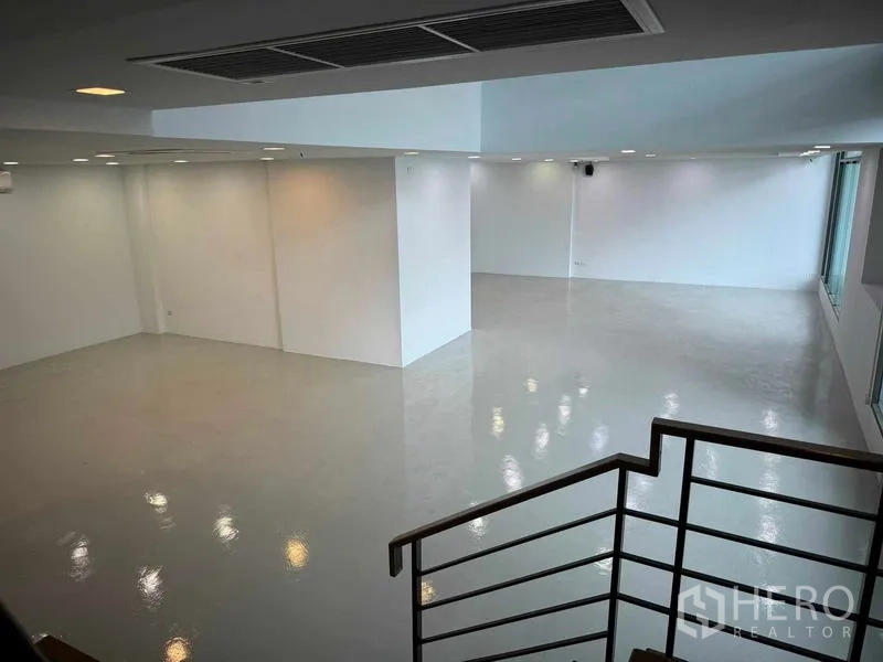 Home Office for rent or sale in Bang Phli, Samut Prakan - Bright double‑height white hall with glossy floor seen from the staircase.