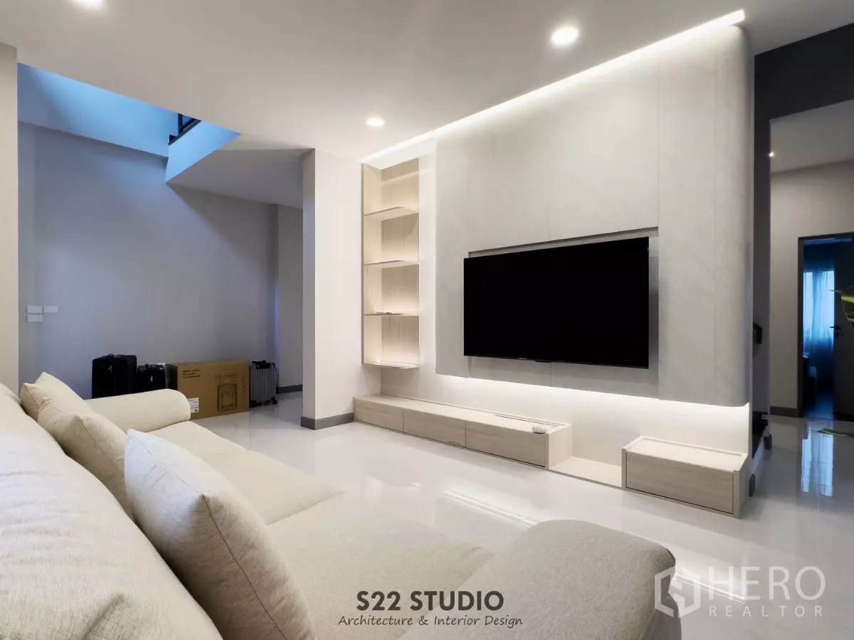 Detached House for rent in Bang Phli, Samut Prakan - Spacious living area with sofa facing an illuminated TV wall and glossy flooring.