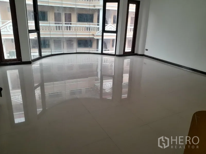 ทาวน์เฮาส์ ให้เช่าในKhlong Toei, Bangkok - ห้องนั่งเล่นกว้าง พื้นกระเบื้องเงา พร้อมหน้าต่างบานโค้งกระจกเต็มบาน รับแสงธรรมชาติ