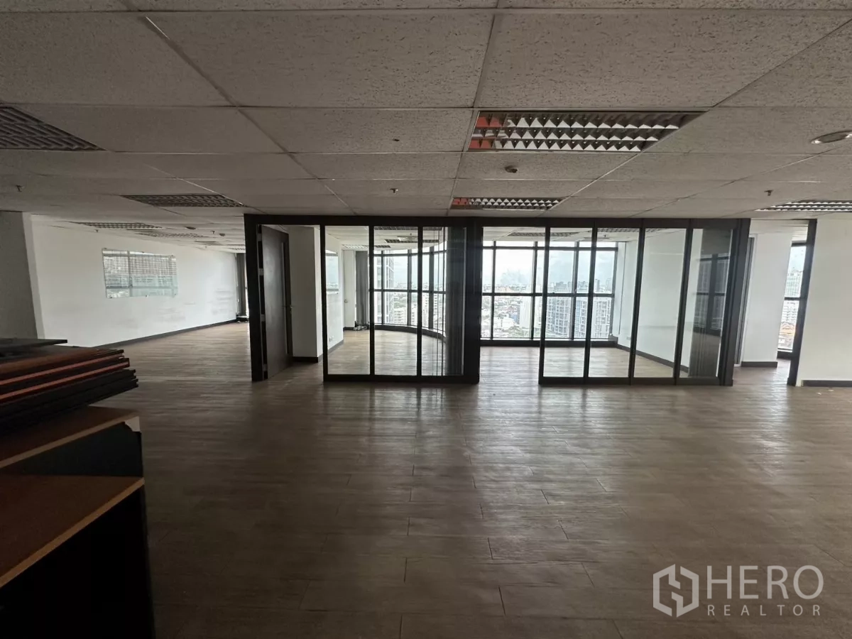 Office Space for rent in Watthana, Bangkok - Central zone showing glass partitions forming private rooms and panoramic windows with urban views.