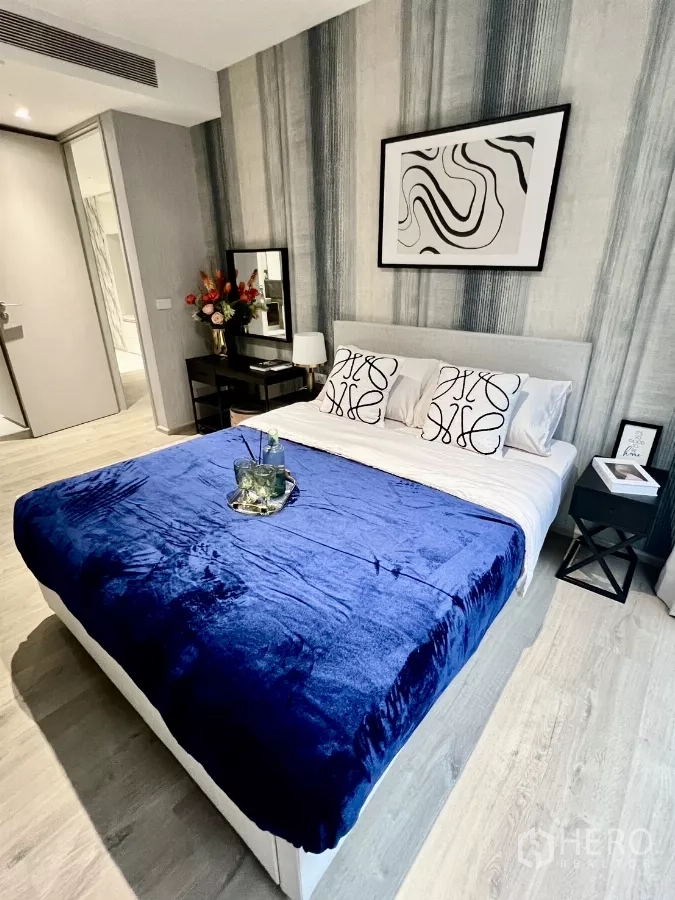 คอนโด ให้เช่าในKhlong Toei, Bangkok - ห้องนอนสไตล์โมเดิร์นพร้อมภาพศิลป์และผ้าคลุมเตียงสีน้ำเงิน