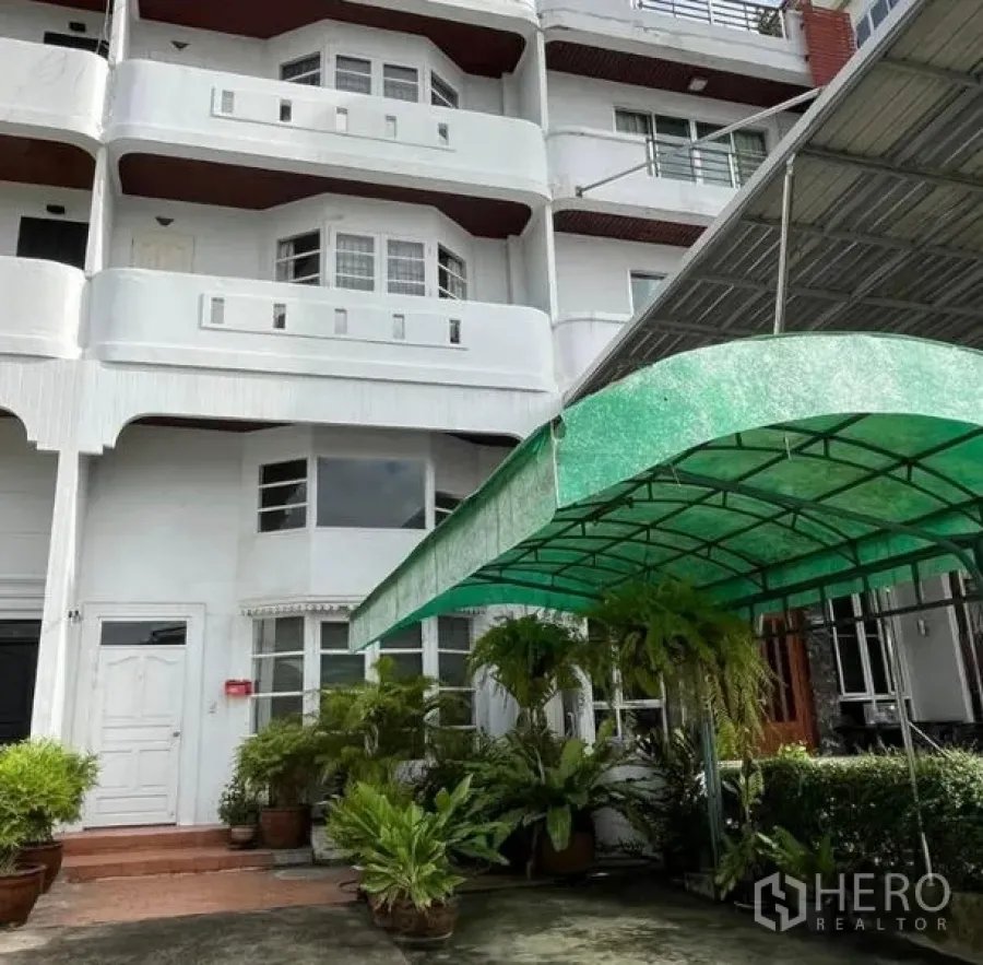 Home Office for rent in Bang Rak, Bangkok - Front elevation showing balconies and a green canopy over the parking area.