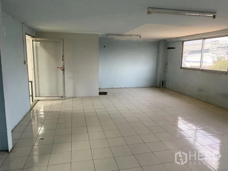 Factory for rent or sale in Bang Phli, Samut Prakan - Tiled office room inside the factory with windows and fluorescent lighting.