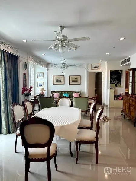 Condominium for rent - Elegant dining room with round table, upholstered chairs and glossy tile floors.