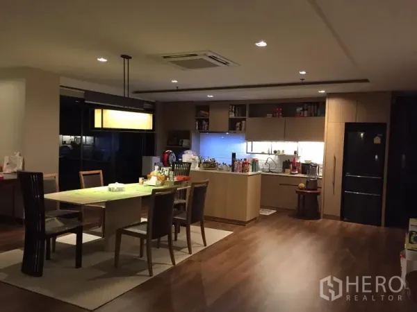 Condominium for sale in Watthana, Bangkok - Open-plan kitchen and dining area with wood cabinetry, island and pendant lighting