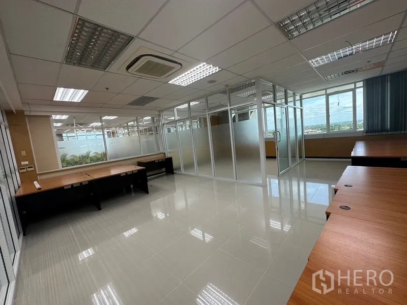 Office Space for rent in Suan Luang, Bangkok - Open office layout with ceiling cassette air-conditioning and multiple glass-walled rooms for meetings.