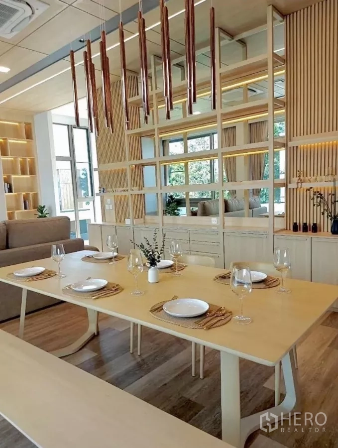 Detached House for rent in Saphan Sung, Bangkok - Dining area with light wood table set for six, mirrored shelving and vertical slat feature wall in Japandi style.