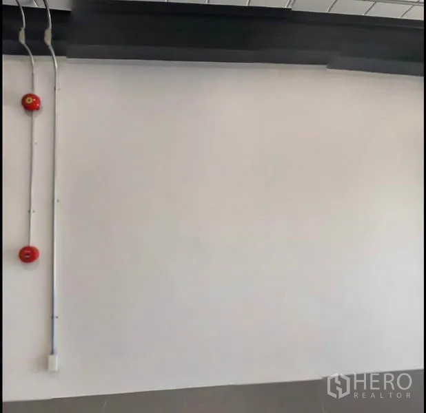 Office Space for rent in Wang Thonglang, Bangkok - Interior wall featuring mounted fire alarms and surface electrical conduits.