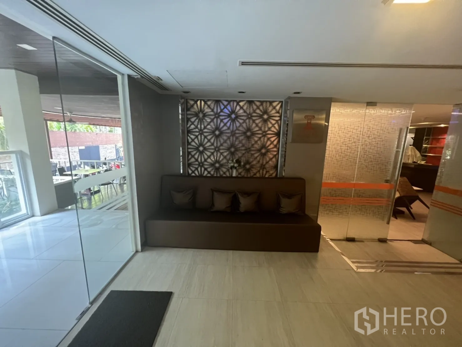 พื้นที่ขายปลีก ให้เช่าในKhlong Toei, Bangkok - มุมรับรองพร้อมเบาะนั่งบิลท์อิน หมอนอิง และผนังกระจกกั้นสู่ระเบียง