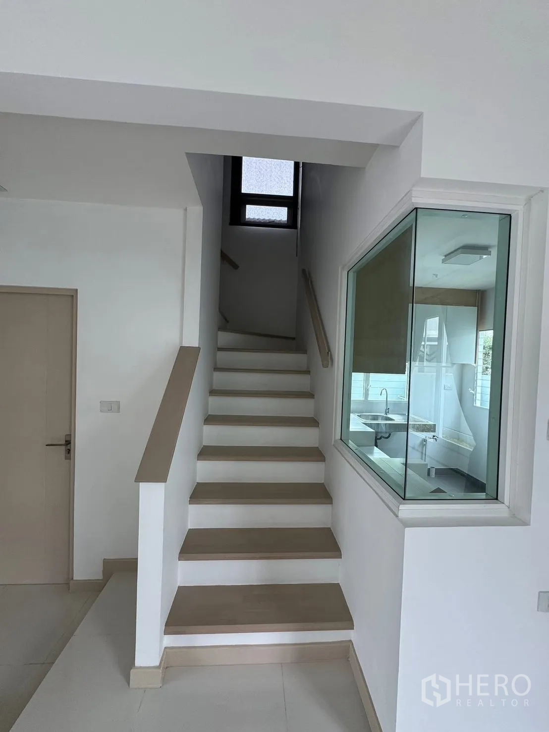 บ้านเดี่ยว for rent in Bang Phli, Samut Prakan - บันไดพร้อมราวจับและช่องหน้าต่างกระจกมองเห็นครัว