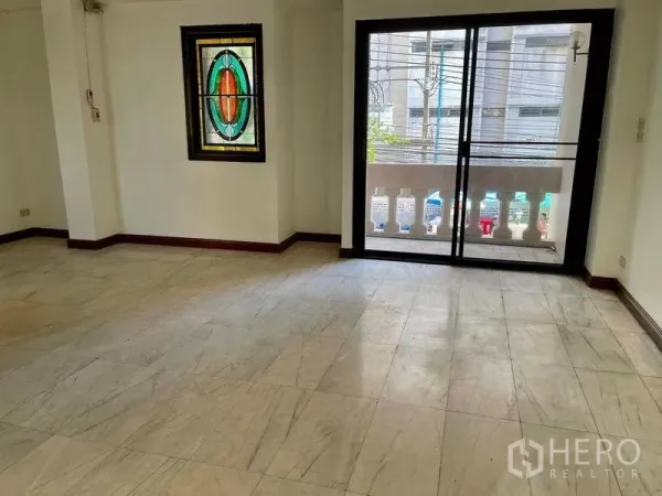 Home Office for rent - Living area with marble-style tiles, stained glass window and sliding doors to a balcony.