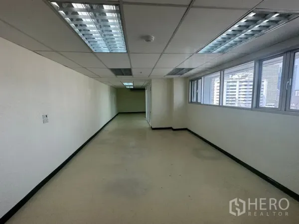 Office Space for rent in Watthana, Bangkok - Long workspace with multiple windows overlooking Bangkok high-rises.
