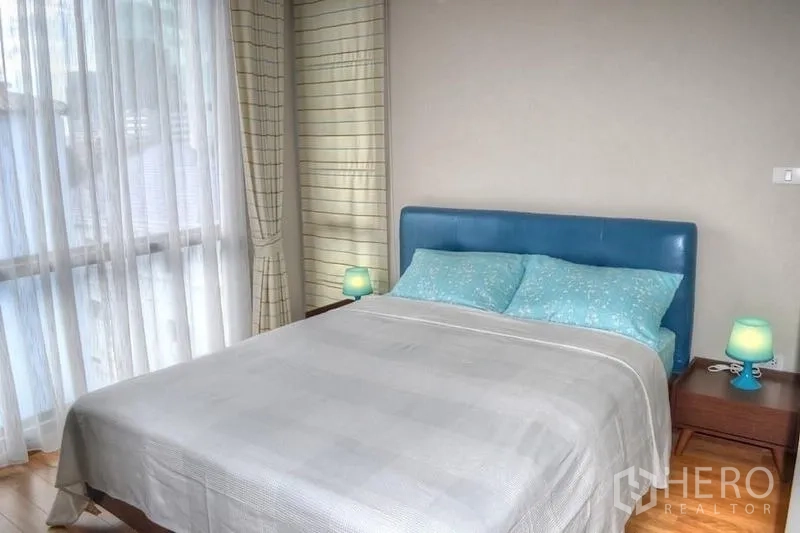 คอนโด ให้เช่าในPhaya Thai, Bangkok - เตียงขนาดควีน หัวเตียงหนังสีน้ำเงิน พร้อมโคมไฟหัวเตียง