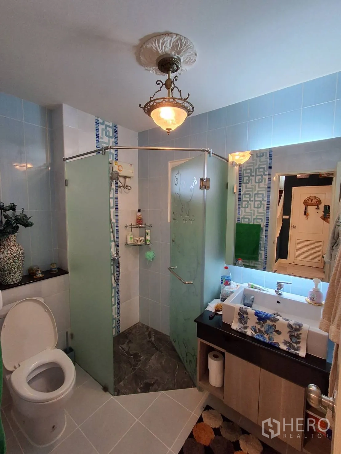 Detached House for rent or sale in Ban Chang, Rayong - Bathroom with glass-enclosed shower, toilet and vanity basin.