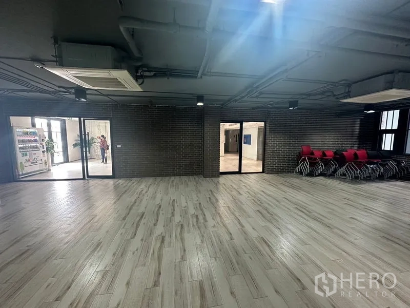 พื้นที่ขายปลีก ให้เช่าในBang Phli, Samut Prakan - ห้องโถงเอนกประสงค์พื้นลายไม้ ผนังก่ออิฐ พร้อมประตูกระจก