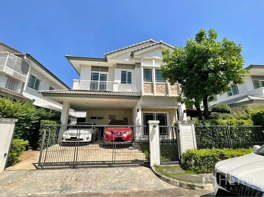 Detached House for sale in Prawet, Bangkok - Front exterior of a two-storey detached house with gated driveway and covered parking.