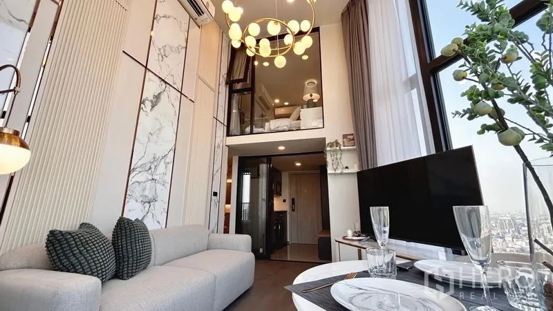 Condominium for rent - Another angle of the loft living area showing chandelier, mezzanine and skyline views.