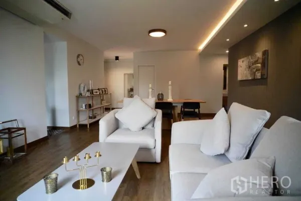 Condominium for rent in Watthana, Bangkok - Spacious open-plan living and dining area with wood floors and recessed lighting.