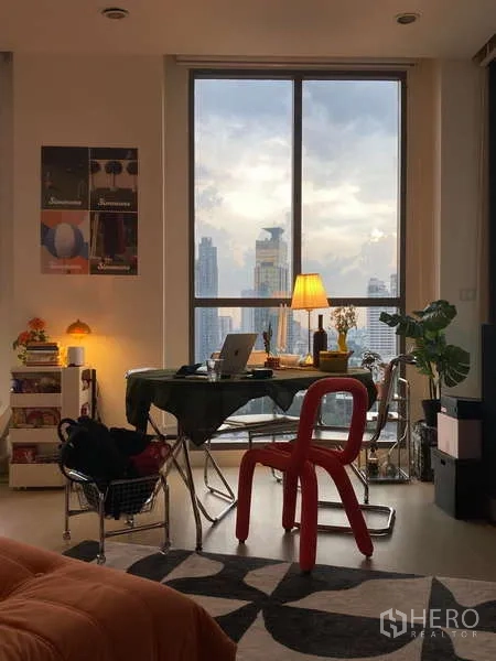 Condominium for rent - Cozy workspace by a floor-to-ceiling window with sunset city views.