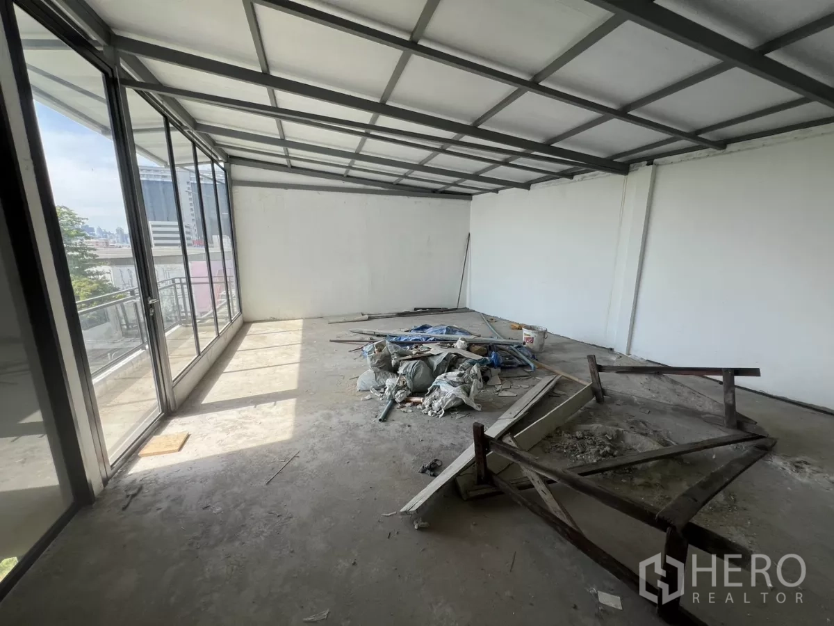 店屋 出售在Suan Luang, Bangkok - 楼上房间，落地推拉玻璃与施工材料。