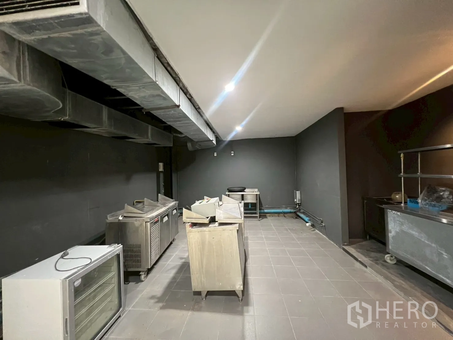 Home Office for rent in Watthana, Bangkok - Another angle of the commercial-style kitchen with ventilation ducts and equipment.