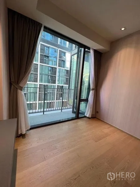 Condominium for rent - Bright room with sliding glass doors opening to a balcony and city views.